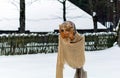 Doll of creature with beard in MeteÃâ i mumming mask and costume staying in the snowy yard
